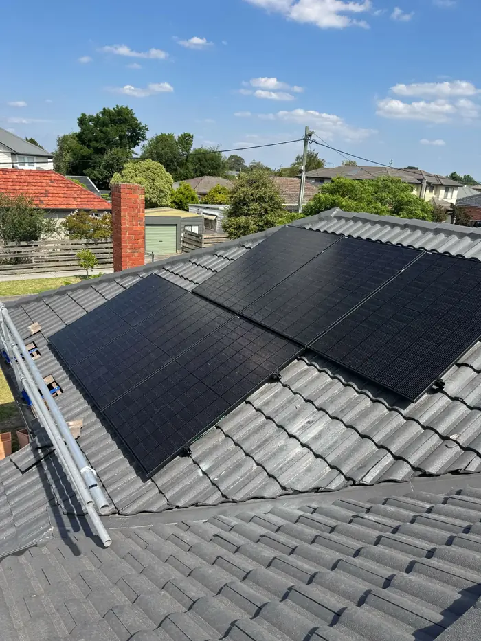 All-black solar panels on a grey tiled roof